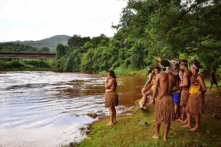 Indigenous people from the Pataxo Ha-ha-hae tribe look at Paraopeba river, after a tailings dam owned by Brazilian mining company Vale SA collapsed, in Sao Joaquim de Bicas near Brumadinho, Brazil January 25, 2019. Picture taken January 25, 2019. REUTERS/FUNAI/Handout via Reuters ATTENTION