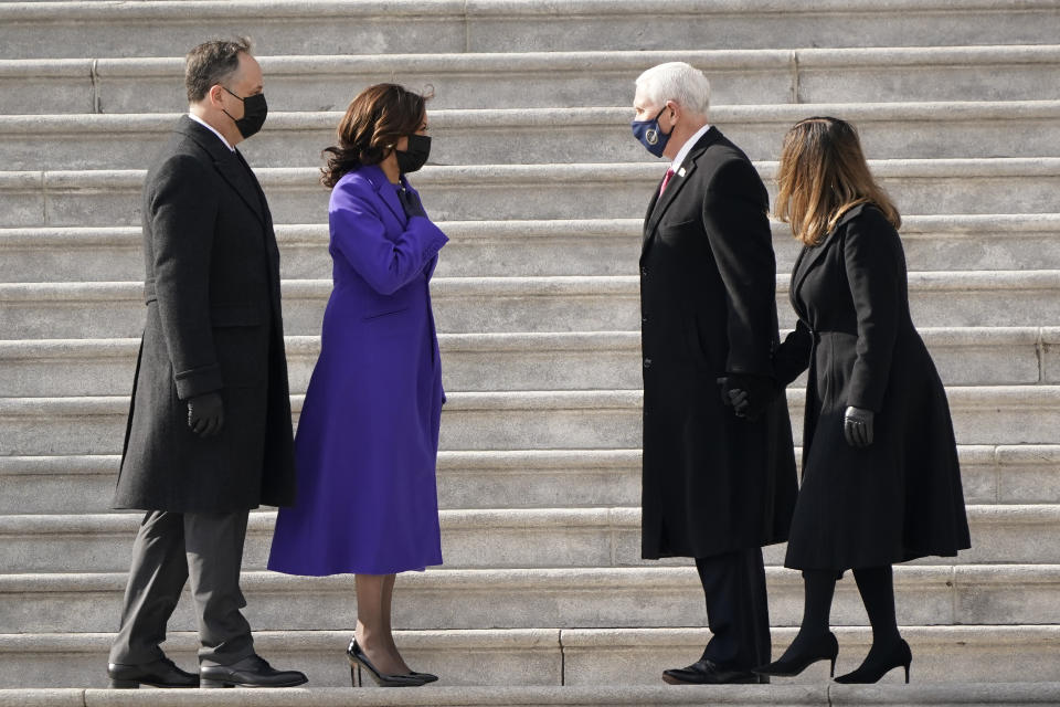 Vice President Kamala Harris and her husband Doug Emhoffl left, and former Vice President Mike Pence and his wife Karen Pence speak before the Pence's depart the Capitol after the Inauguration of President Joe Biden ceremony on the East Front of the Capitol at the conclusion of the inauguration ceremonies, in Washington, Wednesday, Jan. 20, 2021. (AP Photo/J. Scott Applewhite)