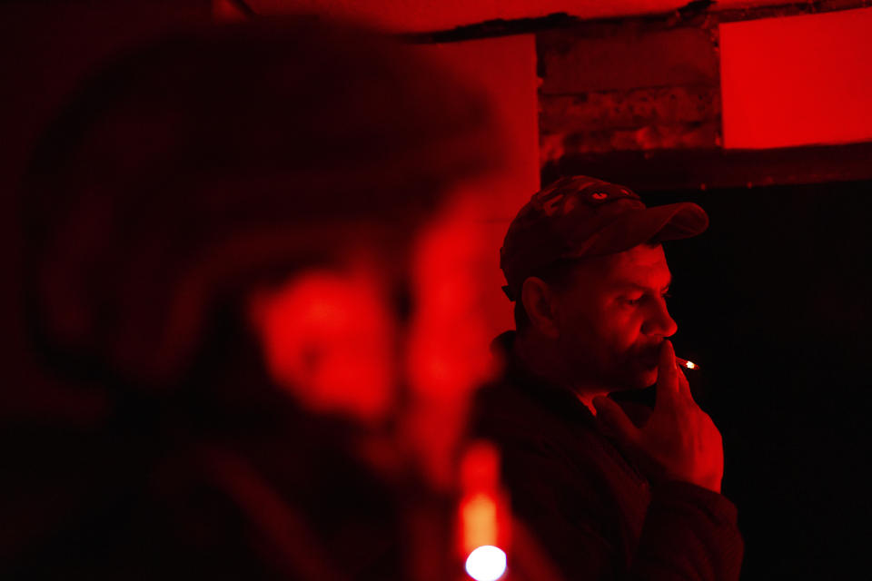 Paramedic evacuation crew driver codename Kum smokes a cigarette with comrades as they wait for injured soldiers in an medical point in the area of Avdiivka close to Donetsk, Ukraine, Saturday, May 4, 2024. (AP Photo/Francisco Seco)