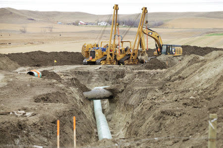 FILE PHOTO: Construction equipment sits near a Dakota Access Pipeline construction site off County Road 135 near the town of Cannon Ball, North Dakota, U.S. on October 30, 2016. REUTERS/Josh Morgan/File Photo