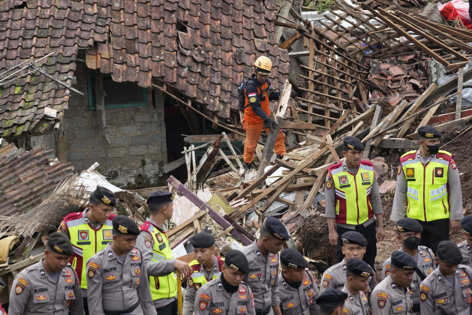 Rescuers search for victims at a village hit by an earthquake-triggered landslide in Cianjur, West Java, Indonesia, Thursday, Nov. 24, 2022. On the fourth day of an increasingly urgent search, Indonesian rescuers narrowed their work Thursday to the landslide where dozens are believed trapped after an earthquake that killed hundreds of people, many of them children. (AP Photo/Tatan Syuflana)