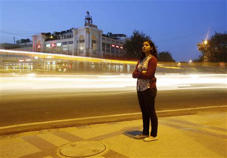 Inayat Naomi Ramdas, 21, poses for a photograph at a busy traffic intersection in New Delhi March 7, 2014. REUTERS/Anindito Mukherjee