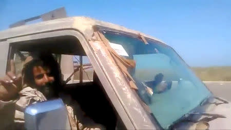 Members of UAE-backed fighters, Yemeni Resistance Giants' Brigade drive the truck near airport on the outskirts of Hodeidah, Yemen, June 19, 2018 in this still image taken from video. YEMENI RESISTANCE GIANTS' BRIGADE/REUTERS