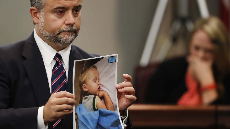 Defense attorney Maddox Kilgore holds a photo of Cooper Harris during Justin Ross Harris' murder trial in 2016. - John Bazemore/AP