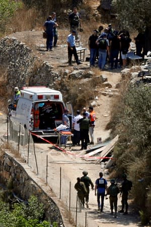 Israeli forces and paramedics gather at the scene of an attack near the Jewish settlement of Dolev in the Israeli-occupied West Bank
