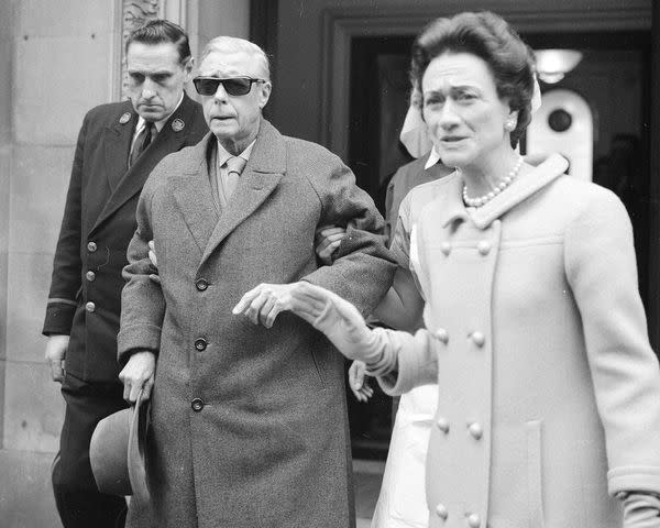 <p>PA Images via Getty</p> The Duke of Windsor leaves the London Clinic with wife Wallis Simpson in March 1965