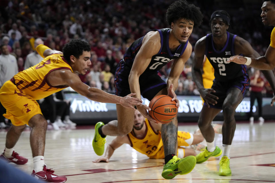 TCU guard Micah Peavy (0) drives to the basket past Iowa State guard Tamin Lipsey (3) during the second half of an NCAA college basketball game, Wednesday, Feb. 15, 2023, in Ames, Iowa. (AP Photo/Charlie Neibergall)