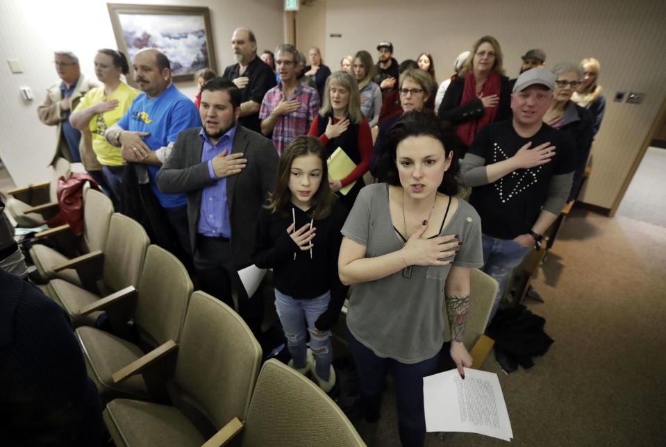 Members of the Orchard City Indivisible Group recite the pledge of allegiance during a city council meeting where they would speak against the policies of President Trump Tuesday, March 7, 2017, in Campbell, Calif. Old-school, anti-capitalist activists and new-school, free-enterprise techies are pushing aside their differences to take on a common foe. (AP Photo/Marcio Jose Sanchez)