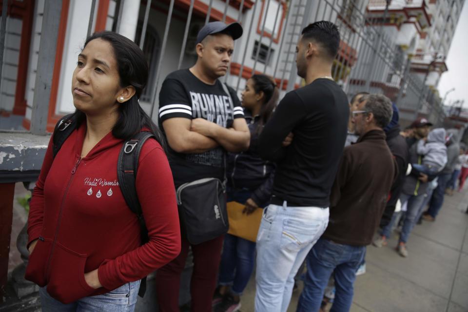Venezuelan migrant Francy Rodriguez, 26, who worked in accounting in Venezuela and now cleans homes in Peru, waits in line outside her embassy in Lima, Peru, Tuesday, Sept. 4, 2018. Rodriguez, a mother of a 2-year-old who moved to Lima at the start of the year, said she can't afford to pay someone to watch her daughter while she works as a maid, so is returning home where she has family. (AP Photo/Martin Mejia)