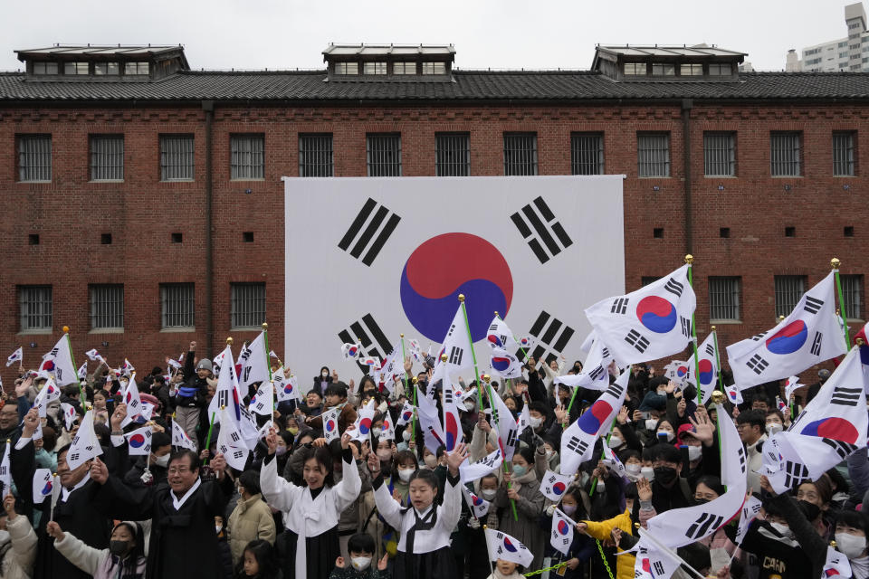 South Koreans give three cheers for the country during a ceremony to celebrate the March First Independence Movement Day, the anniversary of the 1919 uprising against Japanese colonial rule, in Seoul, South Korea, Wednesday, March 1, 2023. (AP Photo/Ahn Young-joon)