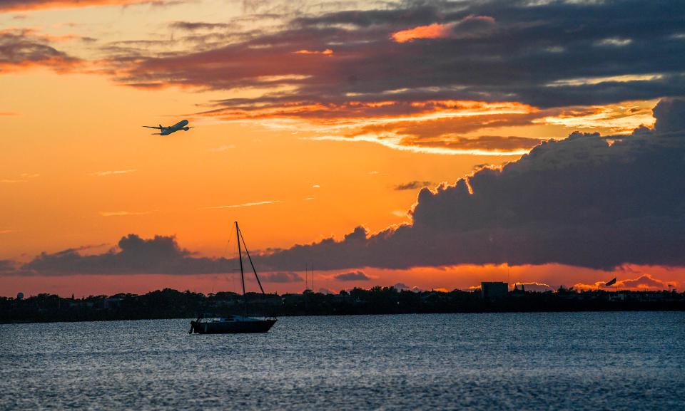 A TUI Airways Boeing 787 Dreamliner takes off from Melbourne Orlando International Airport in October 2022 on its way back to the United Kingdom in this view along the Indian River from Riverside Park in Indialantic.