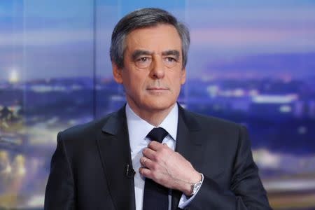 Francois Fillon, former French prime minister, member of The Republicans political party and 2017 presidential candidate of the French centre-right, adjusts his tie prior to a prime-time news broadcast in the studios of TF1 in Boulogne-Billancourt, near Paris, France, January 26, 2017. REUTERS/Pierre Constant/Pool