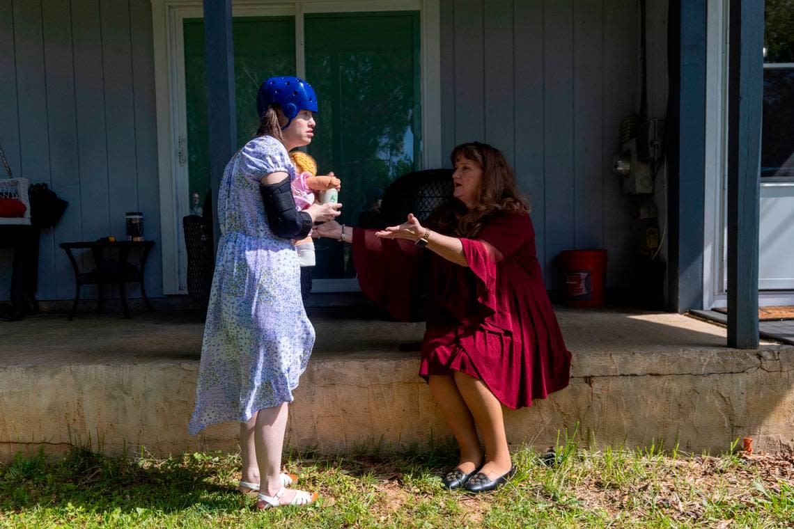 Dana Rhoney spends time with her daughter Samantha, who has a moving disorder and an intellectual disability, at their home near Claremont on Tuesday, April 23, 2024. The Rhoneys filed a lawsuit in 2017 that became known as the Samantha R. case. Disability Rights NC argued that the failure to provide access to community- and home-based behavioral health services violated the rights of people with disabilities. Travis Long/tlong@newsobserver.com