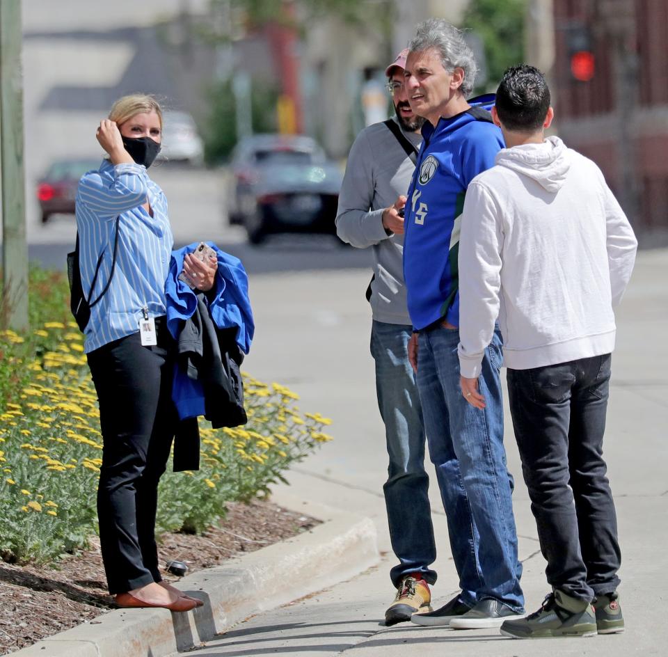 Milwaukee attorney David Gruber (second from right) is seen with a group filming a commercial near the Deer District outside Fiserv Forum in Milwaukee on June 22, 2021.