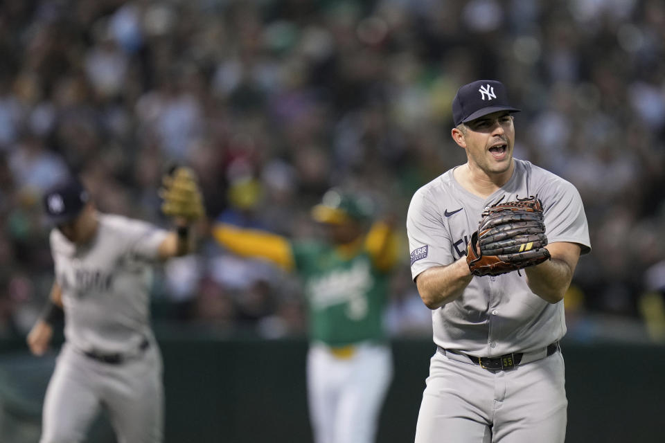 New York Yankees pitcher Carlos Rodón, right, reacts after shortstop Anthony Volpe threw out Oakland Athletics' Brent Rooker at first base to end the third inning of a baseball game Saturday, Sept. 21, 2024, in Oakland, Calif. (AP Photo/Godofredo A. Vásquez)