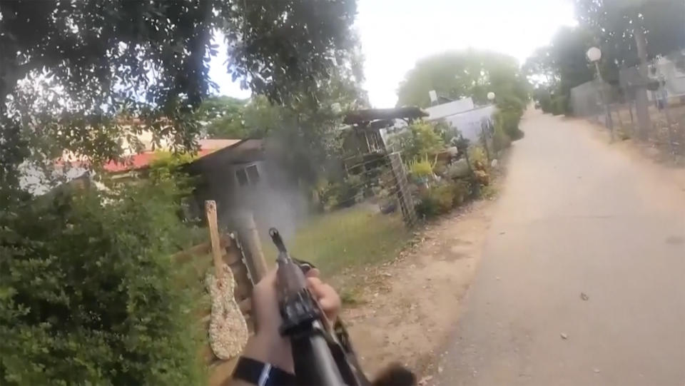 This image made from undated bodycam video footage taken by a downed Hamas militant and released by Israel Defense Forces shows a Hamas militant walking around a residential neighborhood at an undisclosed location in Israel. Israel's military brought together a group of foreign correspondents Monday, Oct. 16, 2023, to screen a 40-minute reel of gruesome footage compiled from the Hamas attack last week. The screening came as Israel's military faces increasing pressure to back up their claims of atrocities committed by the militants. (Israel Defense Forces via AP)