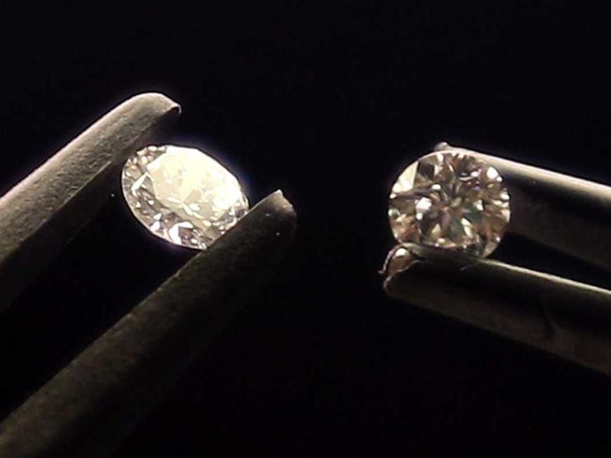 The right one is a 0.41 carat synthetic lab grown diamond and the left one is a slightly larger natural diamond, both visually indistinguishable from each other. 