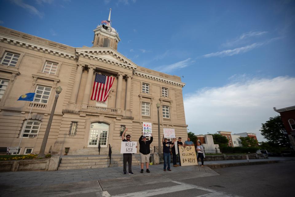 Pro-choice and pro-life demonstrators gather at the steps of the Maury County Courthouse in Columbia Tenn., on Tueday, May 3, 2022.