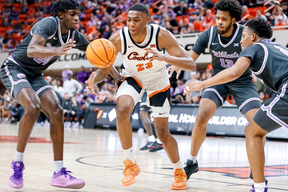 Oklahoma State center Brandon Garrison (23) fights for the ball with Kansas State forward Arthur Kaluma (24)  during Saturday's Big 12 game at Gallagher-Iba Arenia in Stillwater, Okla.