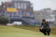 Jason Day of Australia lines up his putt on the 16th green during the first round of the British Open golf championship on the Old Course in St. Andrews, Scotland, July 16, 2015. REUTERS/Paul Childs