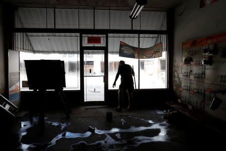 Randy Britt works to clean one of his downtown buildings after flooding due to Hurricane Florence receded in Fair Bluff, North Carolina, U.S. September 29, 2018. REUTERS/Randall Hill