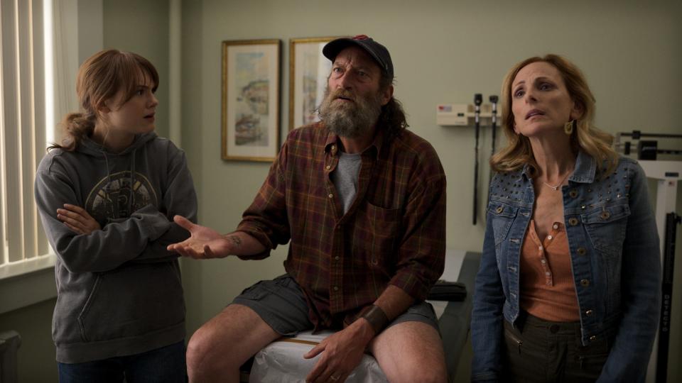 Ruby (Emilia Jones, left) helps translate for her father, Frank (Troy Kotsur), and mother, Jackie (Marlee Matlin), during a doctor's appointment.