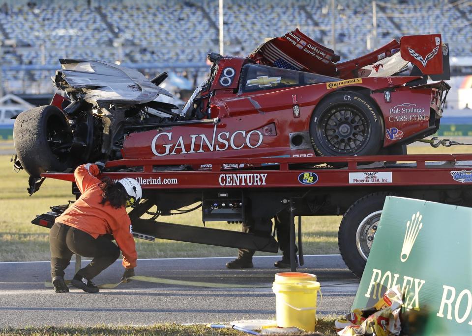 The GAINSCO Corvette DP is loaded on to a wrecker after driver Memo Gidley was involved in a crash during the IMSA Series Rolex 24 hour auto race at Daytona International Speedway in Daytona Beach, Fla., Saturday, Jan. 25, 2014. (AP Photo/John Raoux)