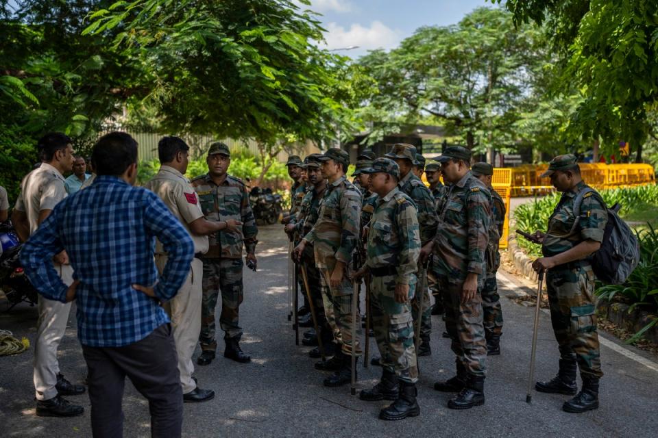 A Delhi police officer briefs a group of Indian paramilitary soldiers outside the Canadian High Commission in Delhi (AP)