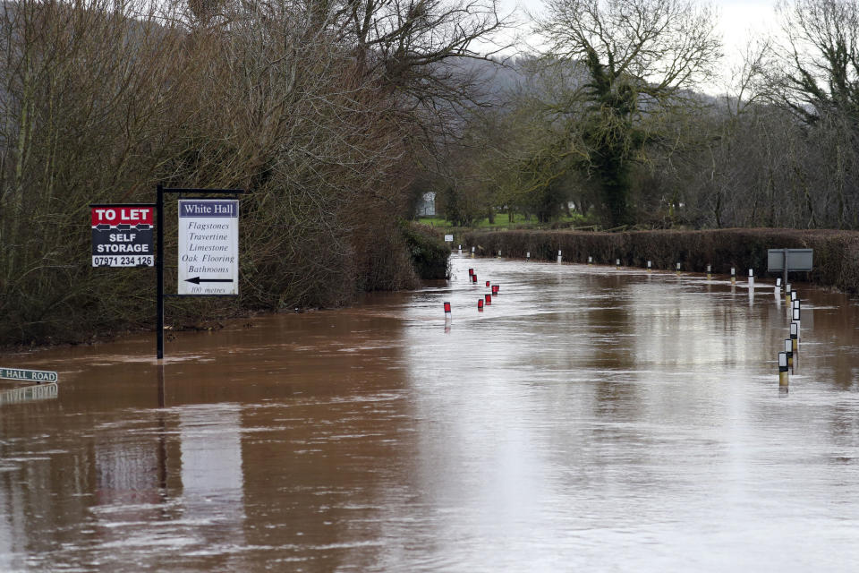 Floodwater surrounds the village of Hampton Bishop near Hereford, after the River Lugg burst its banks, Wales, Tuesday Feb. 18, 2020. Britain's Environment Agency issued severe flood warnings Monday, advising of life-threatening danger after Storm Dennis dumped weeks' worth of rain in some places. (Steve Parsons/PA via AP)