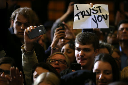 A supporter of U.S. Democratic presidential nominee Hillary Clinton holds a sign which reads " I trust you" during a campaign event in Cleveland, Ohio U.S., October 21, 2016. REUTERS/Carlos Barria