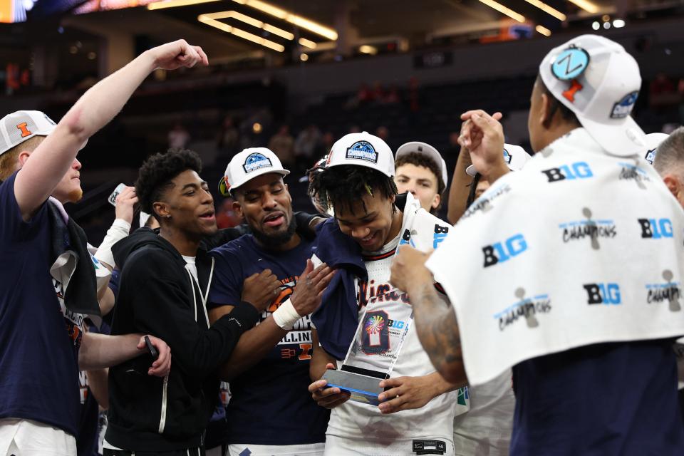Illinois guard Terrence Shannon Jr. (0) and teammates celebrate after the Fighting Illini defeated Wisconsin in the Big Ten championship game at Target Center.