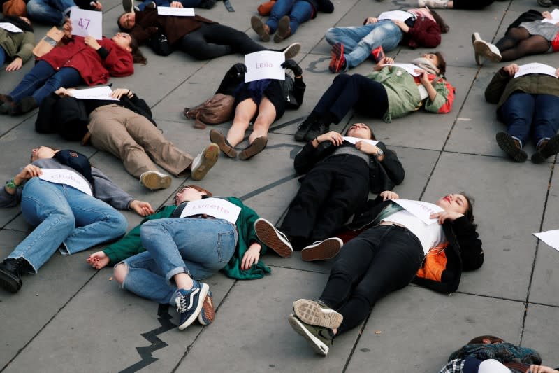 People stage a "die-in" at Place de la Republique during a demonstration against femicide and violence against women in Paris