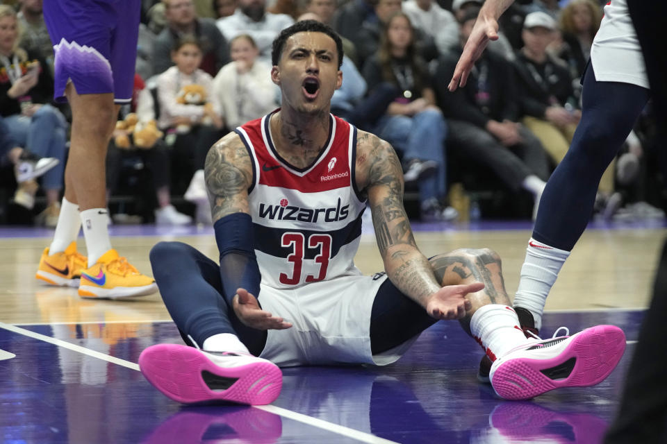 Washington Wizards forward Kyle Kuzma (33) reacts after falling to the court during the second half of an NBA basketball game against the Utah Jazz, Monday, March 4, 2024, in Salt Lake City. (AP Photo/Rick Bowmer)