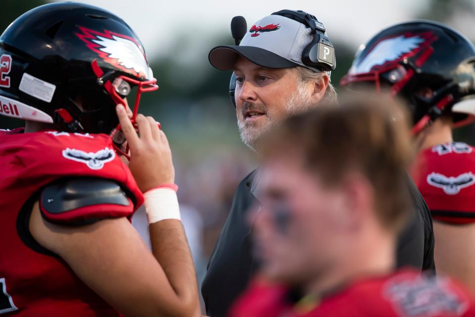 Dover head coach Wayne Snelbaker talks with his players on the sideline during a YAIAA football game against South Western on Friday, September 2, 2022, in Dover. 