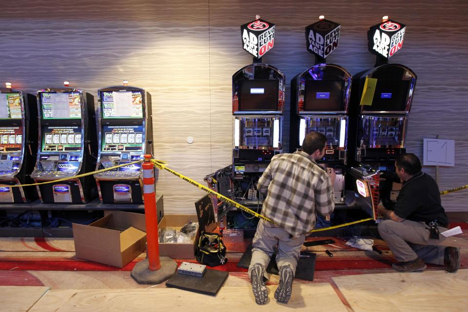 Technicians work on gaming machines at the Valley Forge Casino Resort on Tuesday, Feb. 28, 2012, in Valley Forge. The scheduled public opening is set for March 31. (AP Photo/Matt Rourke)