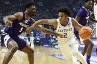 Kentucky's Sahvir Wheeler (2) drives near High Point's Bryant Randleman (5) during the first half of an NCAA college basketball game in Lexington, Ky., Friday, Dec. 31, 2021. (AP Photo/James Crisp)