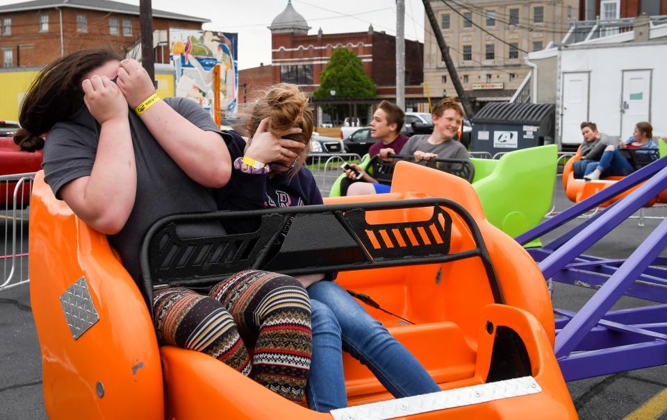 Rides are part of the fun at Tri-Fest, too. Brooklyn Bentley, left, and Faith Mueller ride the scrambler at the 2019 Tri-Fest in downtown Henderson.