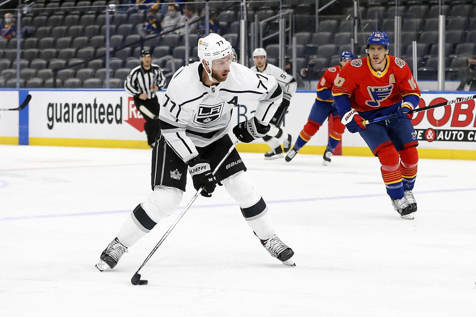 Los Angeles Kings' Jeff Carter (77) handles the puck while under pressure from St. Louis Blues' Brayden Schenn (10) during the first period of an NHL hockey game Monday, Feb. 22, 2021, in St. Louis. (AP Photo/Scott Kane)