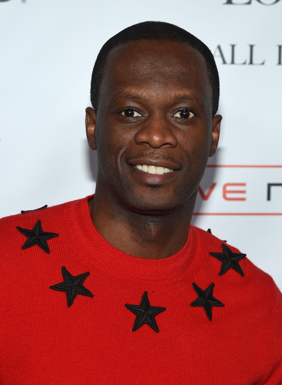 Pras Michel Wearing Red Sweater With Black Stars