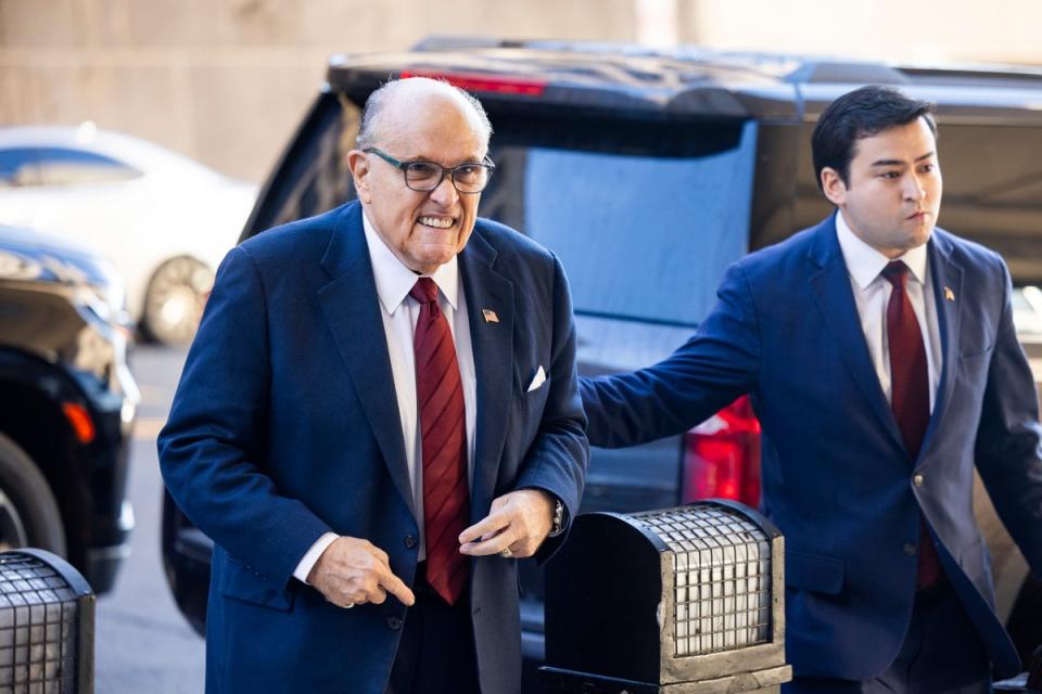 Rudy Giuliani arrives for the first day of a defamation trial in federal court in Washington DC on 11 December (EPA)