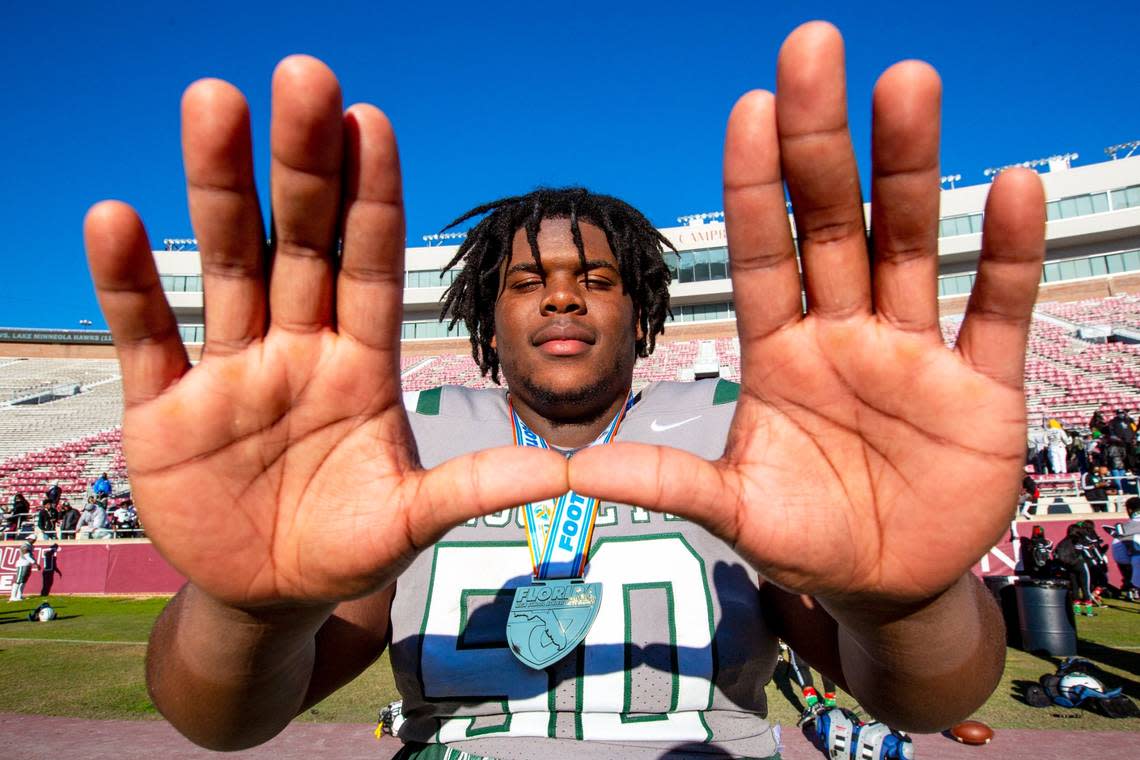 Miami Central guard and University of Miami signee Laurence Seymore (50) celebrates by throwing up ‘The U’ after defeating Lake Minneola 46-0 at Doak Campbell Stadium in Tallahassee, Florida, on Friday, December 18, 2020.