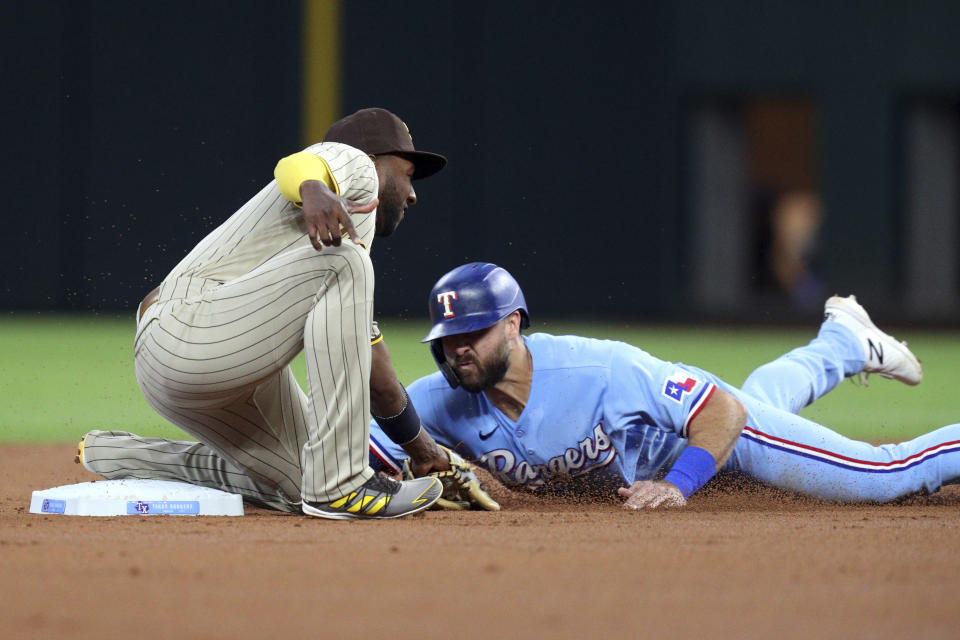 Texas Rangers' Joey Gallo steals second as San Diego Padres second baseman Jurickson Profar tries to tag him in the first inning during a baseball game on Sunday, April 11, 2021, in Arlington, Texas. (AP Photo/Richard W. Rodriguez)