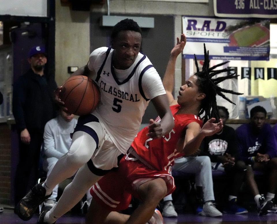Classical Purple Azzy Harrison plows over East Providence Townie Max Collins as he runs the baseline to the basket during the first round of the RIIL State Tournament at the Al Morro Complex on March 2, 2023.