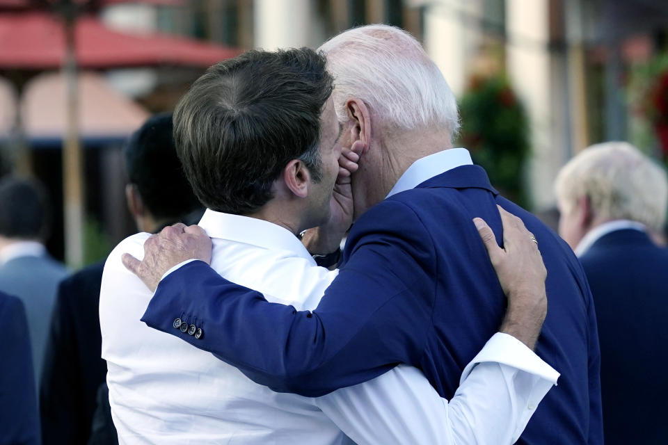 French President Emmanuel Macron whispers to U.S. President Joe Biden following their dinner at the G7 Summit in Elmau, Germany, Sunday, June 26, 2022. (AP Photo/Susan Walsh)