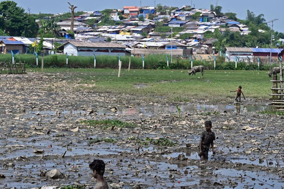 Rohingya refugees stand amid the garbage at a refugee camp in Bangladesh on Sept. 29, 2022. <a href="https://www.gettyimages.com/detail/news-photo/in-this-picture-taken-on-september-29-rohingya-refugees-news-photo/1244091955?phrase=Rohingya%20&adppopup=true" rel="nofollow noopener" target="_blank" data-ylk="slk:Munir uz Zaman/AFP via Getty Images;elm:context_link;itc:0;sec:content-canvas" class="link ">Munir uz Zaman/AFP via Getty Images</a>