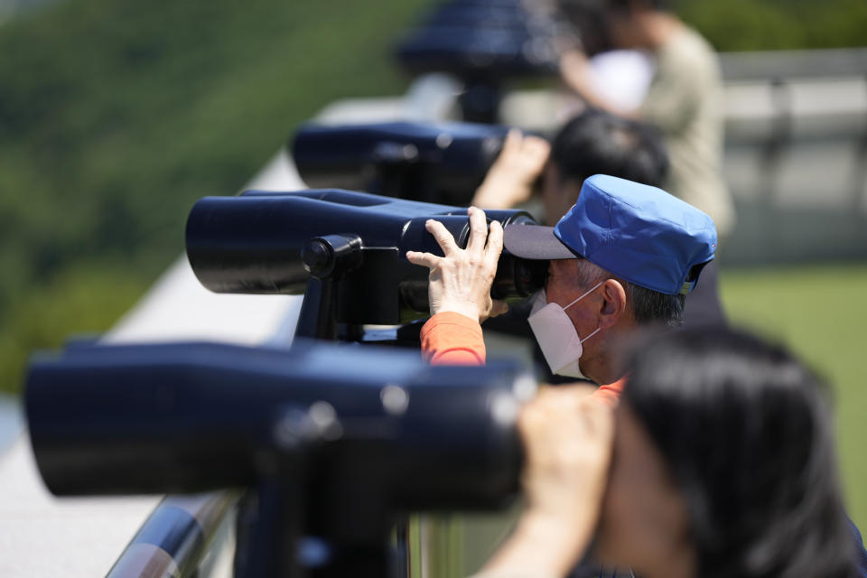 Visitors use binoculars to see the North Korean side from the unification observatory in Paju, South Korea, Tuesday, May 28, 2024. A rocket launched by North Korea to deploy the country's second spy satellite exploded shortly after liftoff Monday, state media reported, in a setback for leader Kim Jong Un's hopes to operate multiple satellites to better monitor the U.S. and South Korea. (AP Photo/Lee Jin-man)