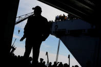 President Trump takes the stage in the flight hangar to deliver remarks aboard the pre-commissioned U.S. Navy aircraft carrier Gerald R. Ford. REUTERS/Jonathan Ernst