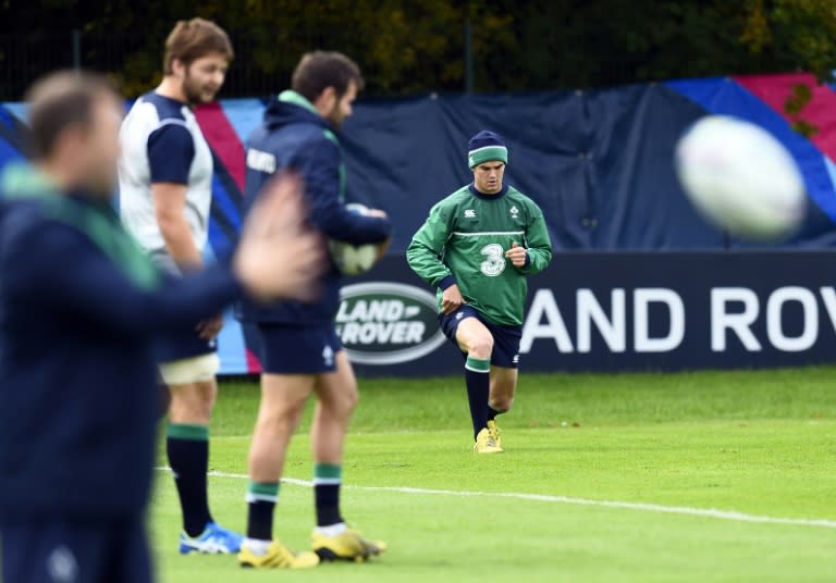 Ireland's fly half Jonathan Sexton (C) stretches during a team training session on October 7, 2015 in Newport, south Wales during the 2015 Rugby union World Cup