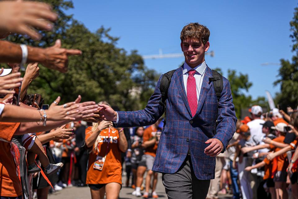 Texas quarterback Arch Manning greets fans as he makes his way into Royal-Memorial Stadium ahead of Saturday's 35-13 win over Mississippi State. The redshirt freshman got his second straight start in place of the injured Quinn Ewers.