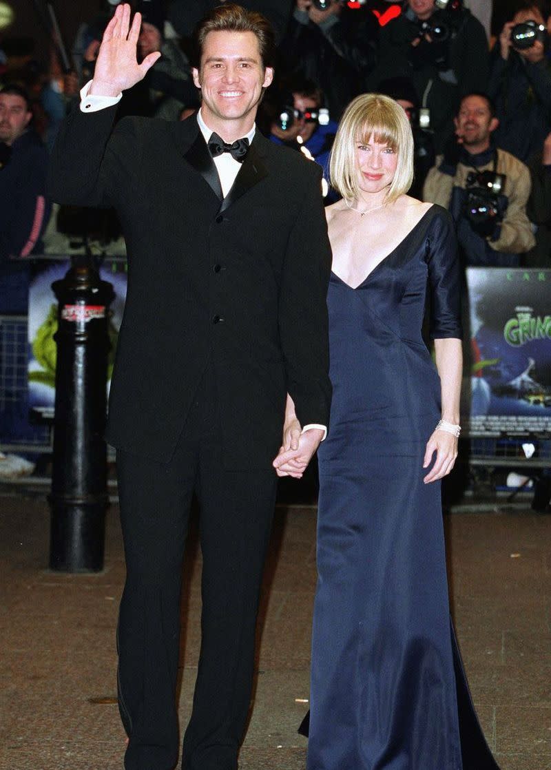 <p>Jim Carrey and Renée Zellweger looked polished in a classic tux and navy gown as they made their way to the reception line to meet the Queen at Carrey’s film, <em>The Grinch</em><em>.</em></p>